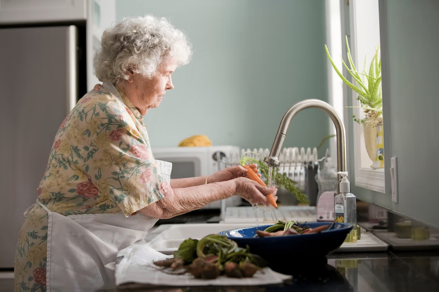 old woman doing the dishes