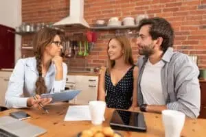 Real estate agent offers the purchase of a home for a young couple