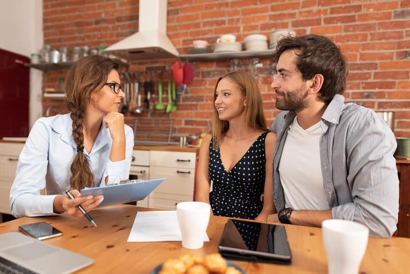 Real estate agent offers the purchase of a home for a young couple