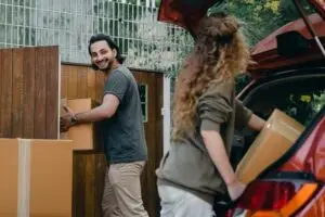 couple unloading boxes from the car