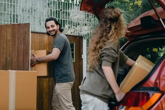 couple unloading boxes from the car