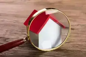 Magnifying glass sitting in front of house model