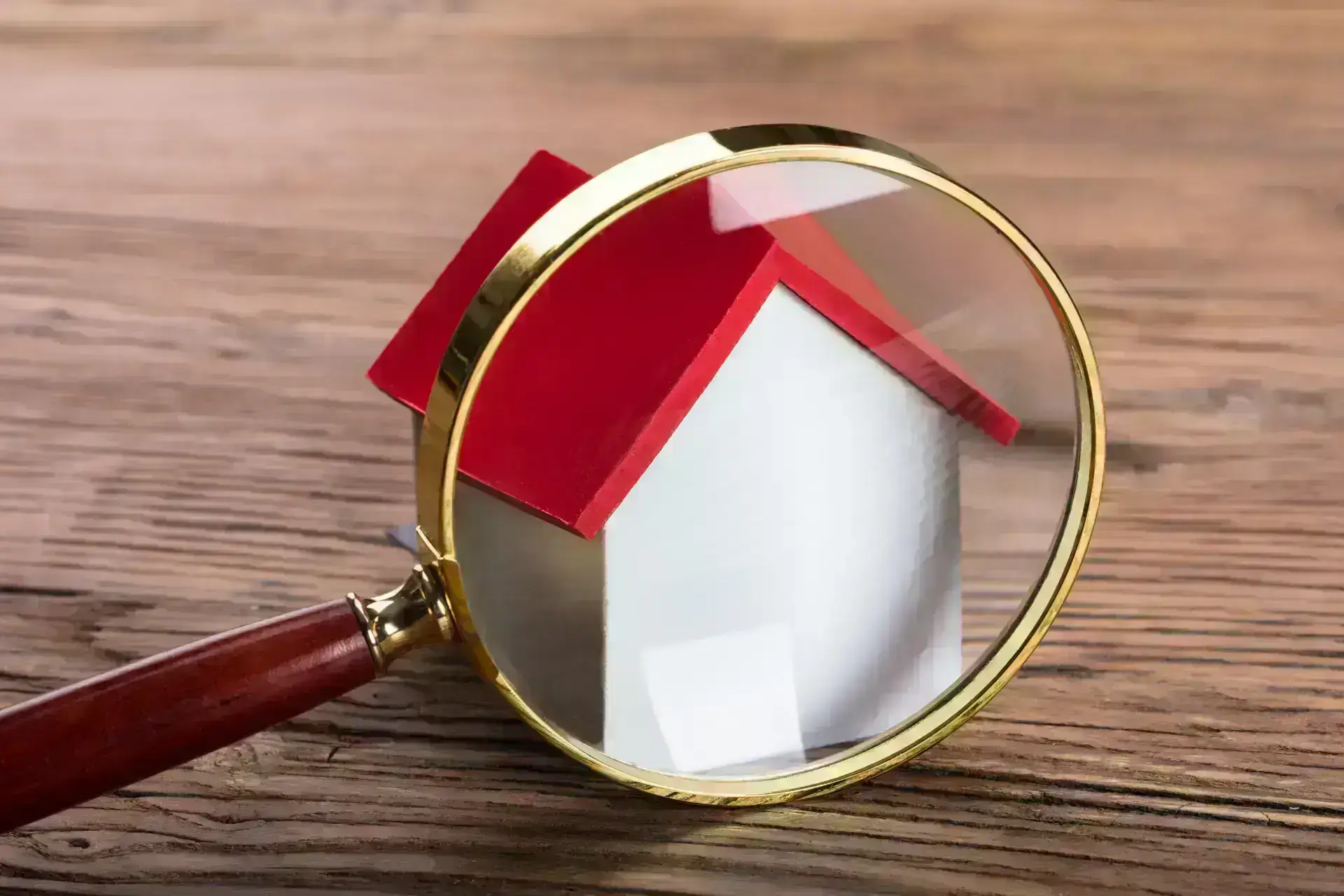 Magnifying glass sitting in front of house model