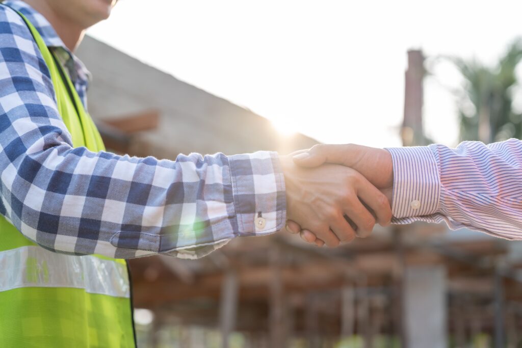 Home inspector shaking hands with someone