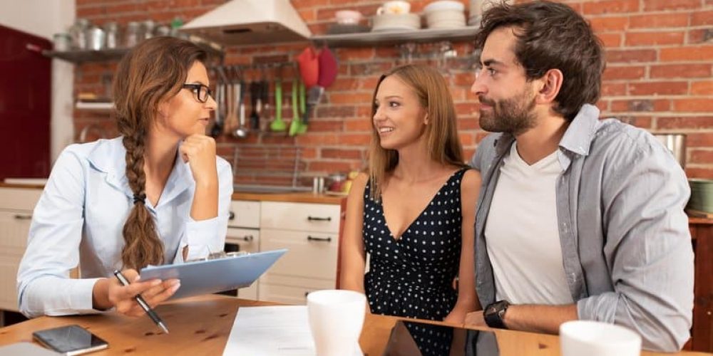 Real estate agent offers the purchase of a home for a young couple
