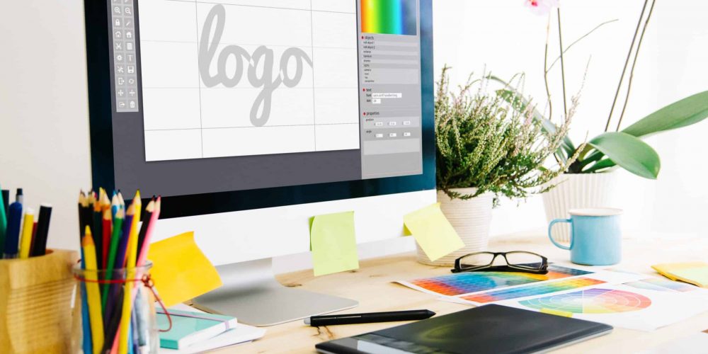 Desk with color guides, desktop computer with logo graphic