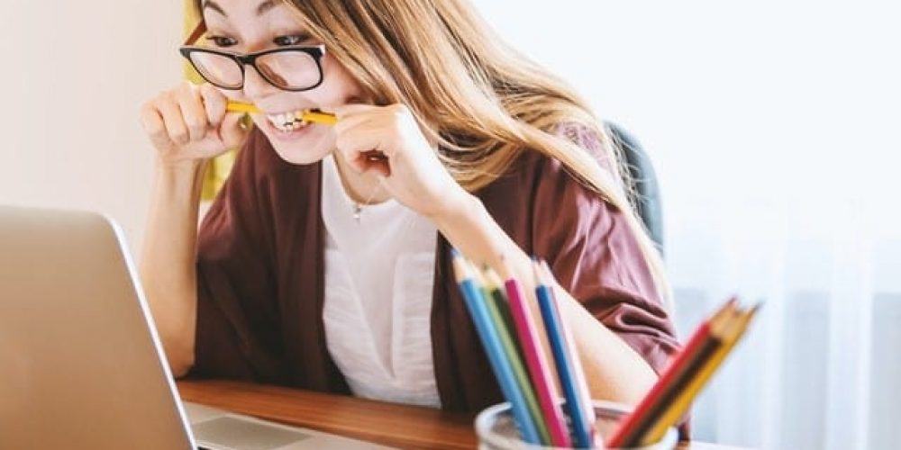 woman biting pencils