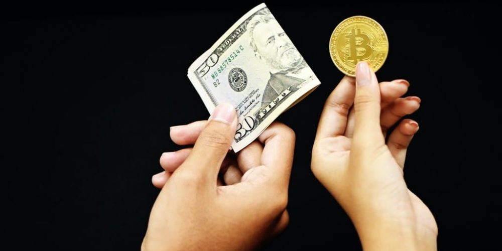 bitcoin and dollar bill